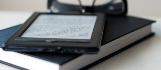 E-Reader and book with reading glasses